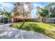 Large backyard with grassy lawn and red storage building at 3336 Florene Dr, Orlando, FL 32806