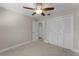 Bedroom with ceiling fan and double door closet at 3336 Florene Dr, Orlando, FL 32806