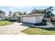 House exterior with paved driveway and landscaping at 3336 Florene Dr, Orlando, FL 32806