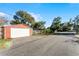 Red metal garage with white door, street view at 3336 Florene Dr, Orlando, FL 32806