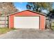 Detached garage with white door and red metal siding at 3336 Florene Dr, Orlando, FL 32806