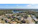 Aerial perspective of a tranquil neighborhood near a lake, showcasing numerous houses at 3437 Starfish Ave, Fruitland Park, FL 34731