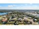 Aerial view of a residential area near a lake and commercial buildings at 3437 Starfish Ave, Fruitland Park, FL 34731