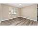 Well-lit bedroom with wood-look floors at 3437 Starfish Ave, Fruitland Park, FL 34731