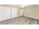 Bright bedroom with large closet and wood-look flooring at 3437 Starfish Ave, Fruitland Park, FL 34731