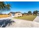 Ranch style home with a large yard, driveway, and attached garage at 3437 Starfish Ave, Fruitland Park, FL 34731