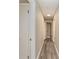 Light neutral hallway with wood-look vinyl flooring at 3437 Starfish Ave, Fruitland Park, FL 34731