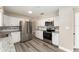 Modern kitchen with white cabinets and granite countertops at 3437 Starfish Ave, Fruitland Park, FL 34731