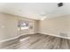 Living room with large bay window, light walls and wood-look floors at 3437 Starfish Ave, Fruitland Park, FL 34731