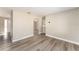 Living room with wood-look floors and view to dining area at 3437 Starfish Ave, Fruitland Park, FL 34731