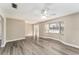 Bright living room with wood-look floors and bay window at 3437 Starfish Ave, Fruitland Park, FL 34731