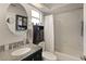 Modern bathroom with granite vanity, a bathtub, and a large mirror at 36703 Sandy Ln, Grand Island, FL 32735