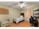 Simple bedroom with a twin bed, a desk, and an armchair at 36703 Sandy Ln, Grand Island, FL 32735