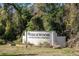 The Wedgewood community sign surrounded by lush greenery. A deed restricted community at 36703 Sandy Ln, Grand Island, FL 32735