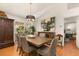 Elegant dining room featuring a modern chandelier, a large wood table, and access to the patio at 36703 Sandy Ln, Grand Island, FL 32735