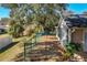 Side yard view of the home's exterior and chain link fence at 36703 Sandy Ln, Grand Island, FL 32735