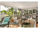 Bright Florida room with wicker furniture, a glass table and view of backyard at 36703 Sandy Ln, Grand Island, FL 32735