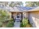 Inviting front entryway with decorative wrought iron details and a covered porch area at 36703 Sandy Ln, Grand Island, FL 32735