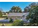 House side view with white fence and landscaping at 36703 Sandy Ln, Grand Island, FL 32735