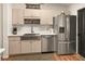 Well-lit kitchen featuring stainless steel appliances, a farm sink, and light-colored cabinetry at 36703 Sandy Ln, Grand Island, FL 32735