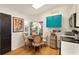 Cozy kitchen nook with bright bay window, blue cabinets, and hardwood floors at 36703 Sandy Ln, Grand Island, FL 32735