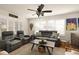 Relaxing living room with reclining sofas, a coffee table, and plantation shutters at 36703 Sandy Ln, Grand Island, FL 32735