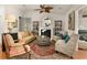 Comfortable living room with neutral tones, a decorative fireplace, and stylish furnishings at 36703 Sandy Ln, Grand Island, FL 32735