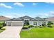 Beautiful two-story house with a three-car garage and landscaped lawn at 3795 View Path, The Villages, FL 32163