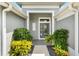 Inviting entryway with lush landscaping and a modern front door at 3795 View Path, The Villages, FL 32163