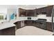 Modern kitchen with dark cabinetry, white backsplash and high-end appliances at 3795 View Path, The Villages, FL 32163