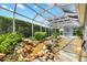 Relaxing screened patio with water feature and flagstone path at 3795 View Path, The Villages, FL 32163