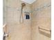 Clean shower with beige tile, built-in niche, and safety grab bar at 3795 View Path, The Villages, FL 32163