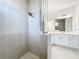 Modern bathroom with a large shower and white cabinets at 3951 Kennebunk Loop, Mount Dora, FL 32757