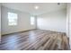 Spacious bedroom with wood-look flooring and neutral walls at 3951 Kennebunk Loop, Mount Dora, FL 32757