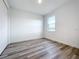 Bedroom with hardwood floors and window, showing a closet at 3951 Kennebunk Loop, Mount Dora, FL 32757