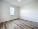 Simple bedroom with hardwood floors and a window at 3951 Kennebunk Loop, Mount Dora, FL 32757