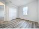 Well-lit bedroom featuring hardwood floors and a window at 3951 Kennebunk Loop, Mount Dora, FL 32757