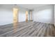 Spacious bedroom with wood-look flooring and access to closet and bath at 3951 Kennebunk Loop, Mount Dora, FL 32757