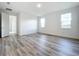 Bright bedroom with wood-look flooring and access to bath and closet at 3951 Kennebunk Loop, Mount Dora, FL 32757