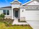 Front entry of a house with stone accents and a walkway at 3951 Kennebunk Loop, Mount Dora, FL 32757