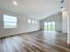 Bright and airy living room with wood-look floors and large windows at 3951 Kennebunk Loop, Mount Dora, FL 32757