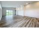 Spacious living room with wood-look flooring and sliding glass doors at 3951 Kennebunk Loop, Mount Dora, FL 32757