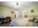 Cozy bedroom with built-in desk and adjacent bathroom access at 401 Cherry Tree St, Eustis, FL 32726