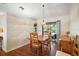 Bright dining area with wood table and chairs, leading to a screened patio at 401 Cherry Tree St, Eustis, FL 32726