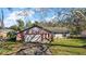 Brick ranch home with attached garage and well-manicured lawn at 401 Cherry Tree St, Eustis, FL 32726