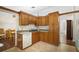 Kitchen with wood cabinets, tile floors, and a dishwasher at 401 Cherry Tree St, Eustis, FL 32726