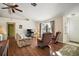 Living room with hardwood floors, comfy seating, and a large window at 401 Cherry Tree St, Eustis, FL 32726