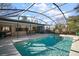 Enjoy this refreshing pool with a screened enclosure and patio furniture at 401 Cherry Tree St, Eustis, FL 32726