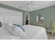 Guest bedroom with double bed, dresser, and ceiling fan at 4063 Deskin Ln, The Villages, FL 32163