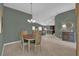 Dining room with a round table and chairs, adjacent to the living room at 4063 Deskin Ln, The Villages, FL 32163